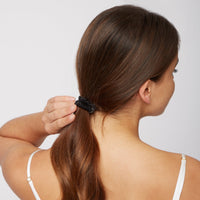 Woman wearing a Silk Large Scrunchie in Black from Dore and Rose