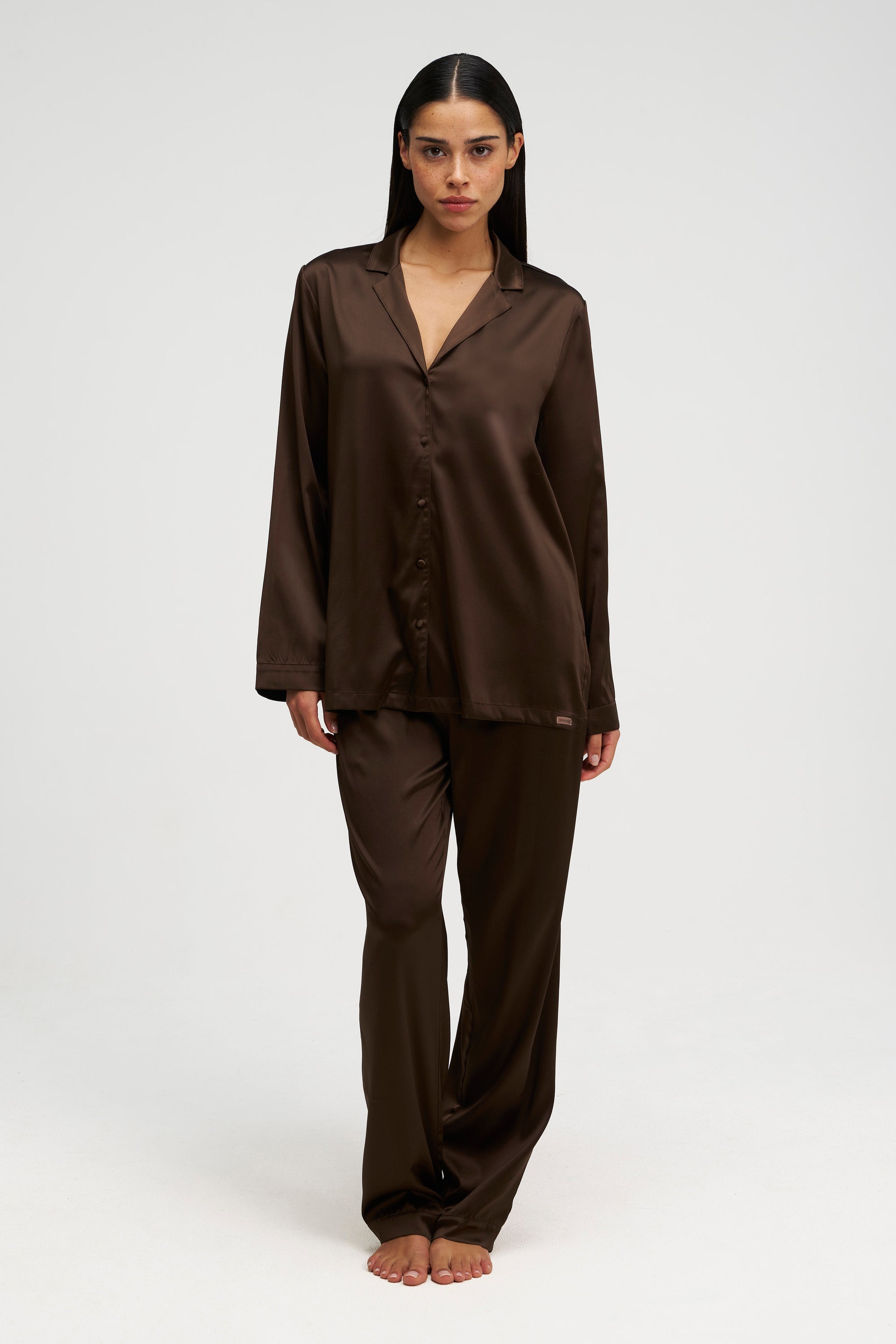 Woman wearing silk PJ in brown, front shot.
