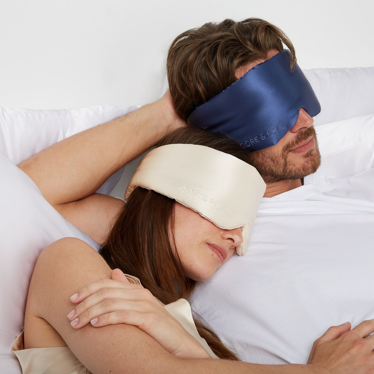 Couple sleeping comfortably with silk sleep masks