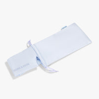 Top view of the silk pouch from Dore and Rose and a Luxury Soft Silk Sleeping Eye Mask inside both in Blue and White stripes 