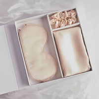 What's in the box of the Dore and Rose Skin Recovering Sleep Bundle in the color Champagne Beige? A Soft Silk Eye Mask for a well rested eyes, Silk Pillowcase for a Luxury feel when you sleep and a Silk Scrunchie to keep your hair in place while maintaining it soft and tangle free