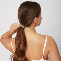 Woman wearing a Silk Large Scrunchie in Olive Green from Dore and Rose